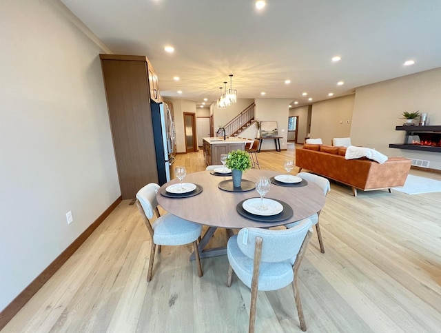 dining room with sink and light hardwood / wood-style floors