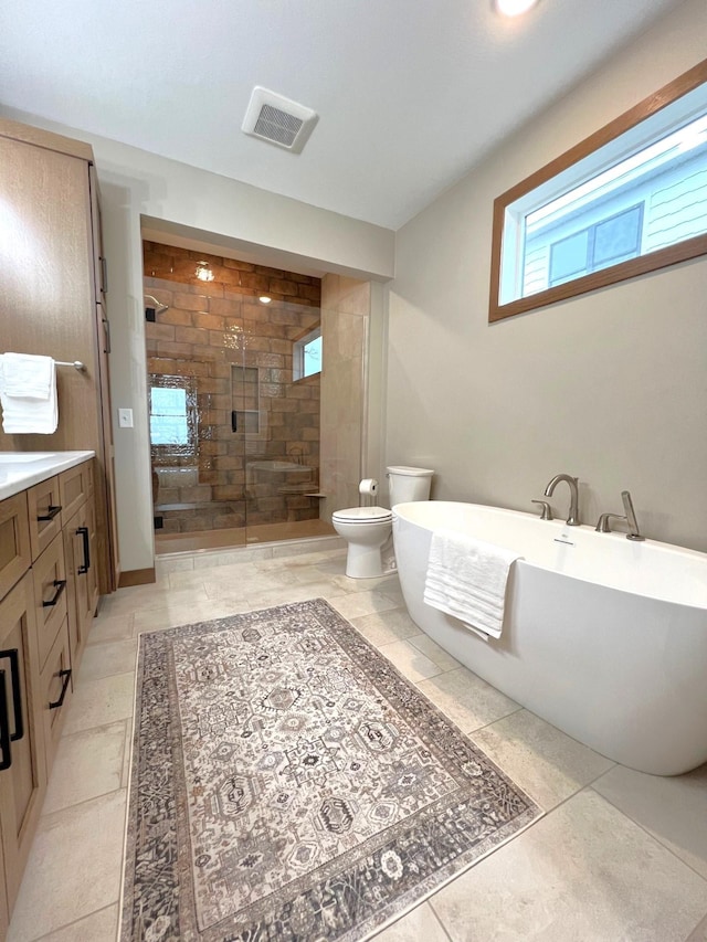 full bathroom with vanity, independent shower and bath, and toilet