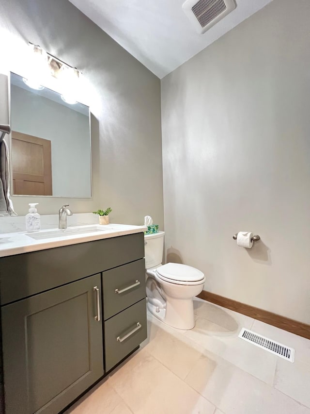 bathroom featuring vanity, tile patterned floors, and toilet