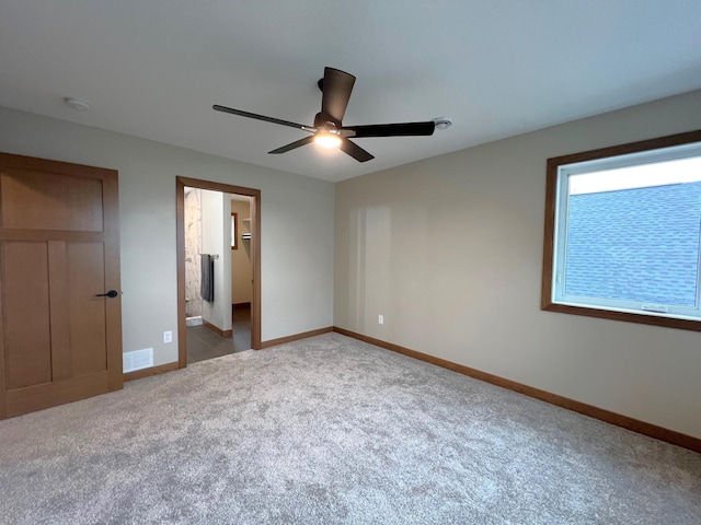 unfurnished bedroom with ensuite bathroom, ceiling fan, and carpet flooring