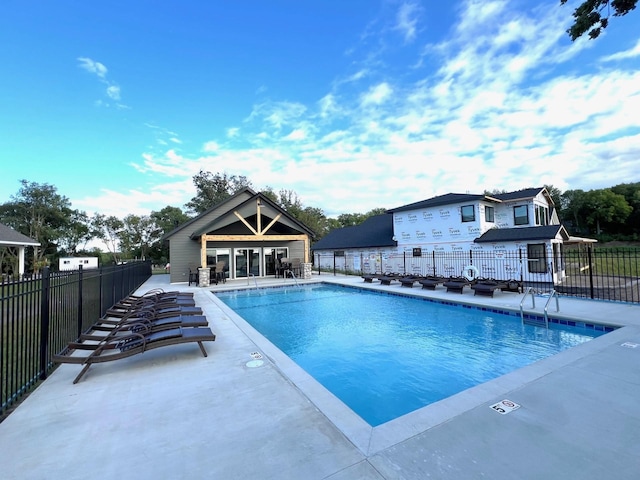 view of swimming pool featuring an outbuilding and a patio area