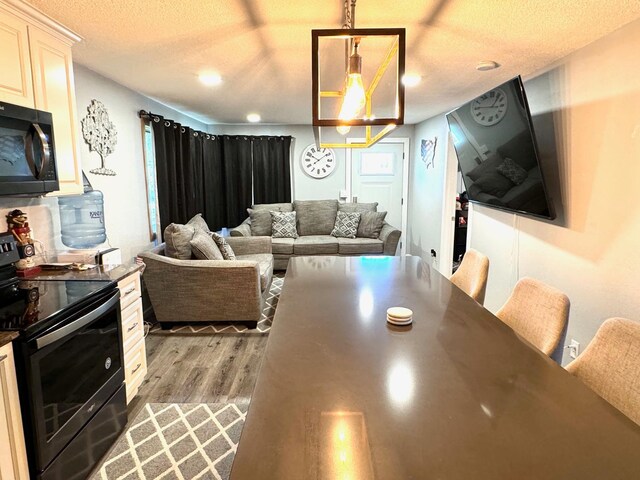 living room with light hardwood / wood-style flooring and a textured ceiling