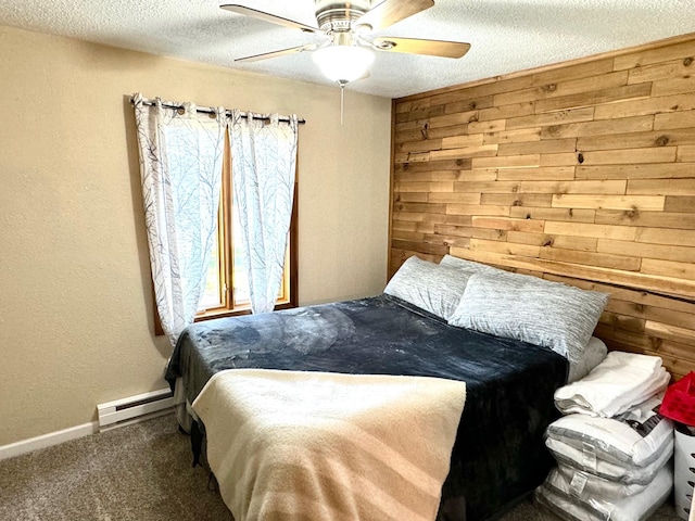 bedroom featuring a baseboard heating unit, carpet, ceiling fan, and wooden walls