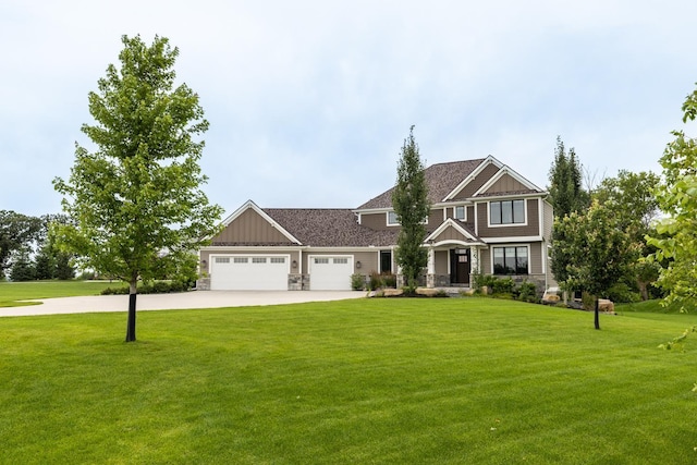 craftsman inspired home featuring a garage and a front lawn