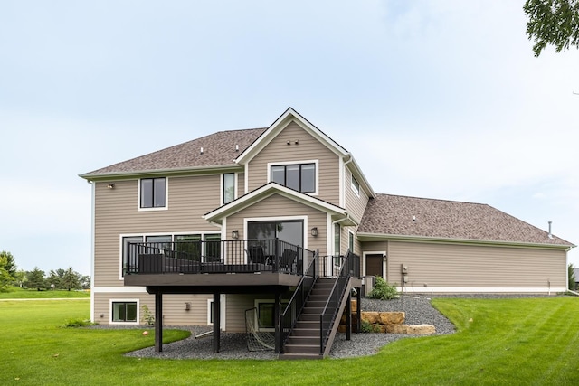 rear view of property featuring central AC unit, a yard, and a deck