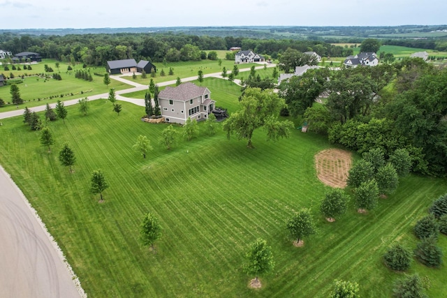 birds eye view of property with a rural view