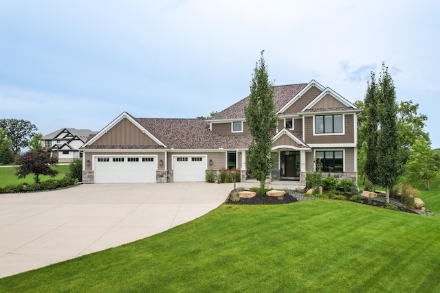 craftsman-style home featuring a garage and a front yard