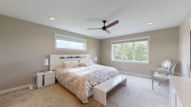 carpeted bedroom featuring ceiling fan and multiple windows