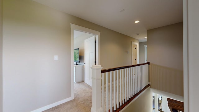 hall featuring light carpet