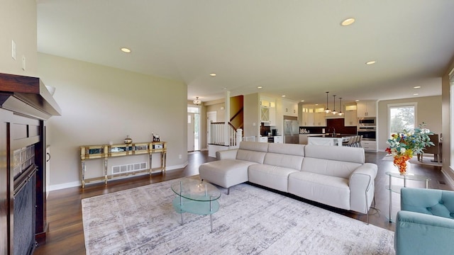 living room featuring hardwood / wood-style flooring and sink