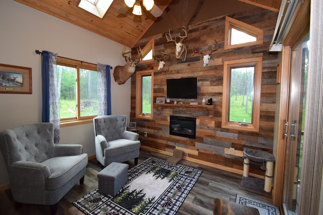 living room with a stone fireplace, hardwood / wood-style floors, wood ceiling, and wooden walls