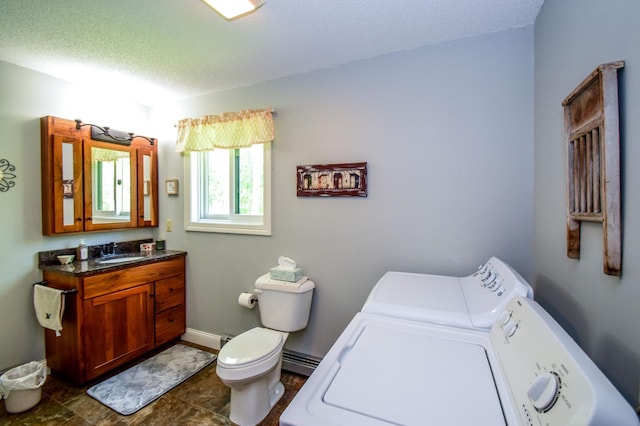 bathroom with separate washer and dryer, vanity, toilet, tile patterned floors, and a textured ceiling