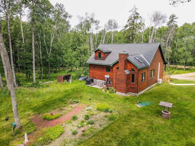 view of home's exterior with cooling unit and a lawn