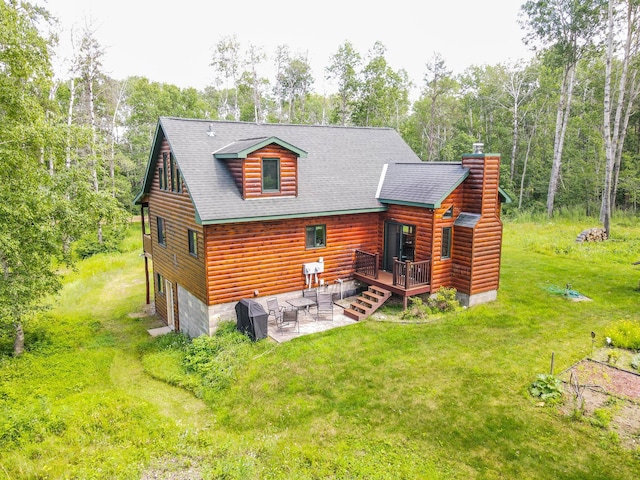 back of property with a lawn, a patio, and a deck