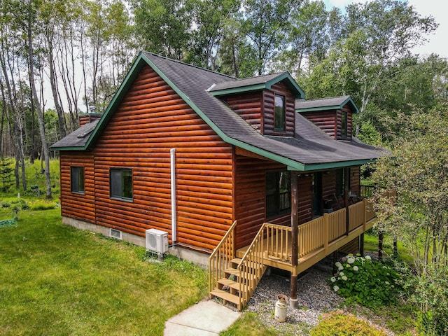 rear view of house featuring a lawn