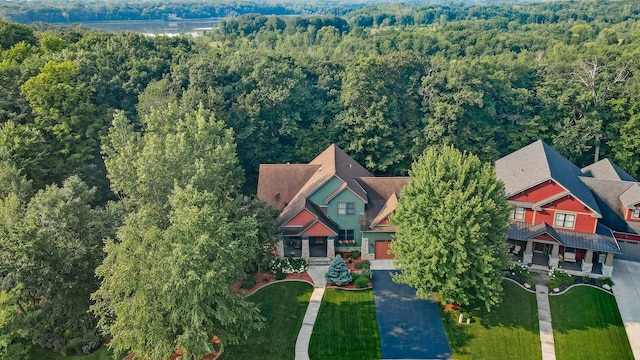 bird's eye view with a wooded view