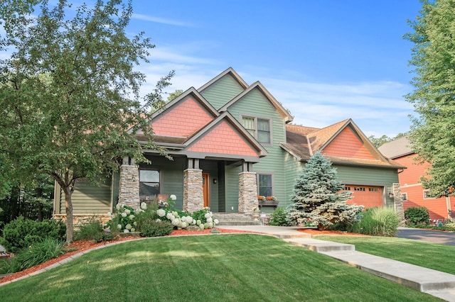 craftsman inspired home featuring a garage, stone siding, and a front yard