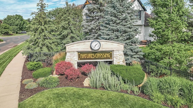 community sign featuring fence