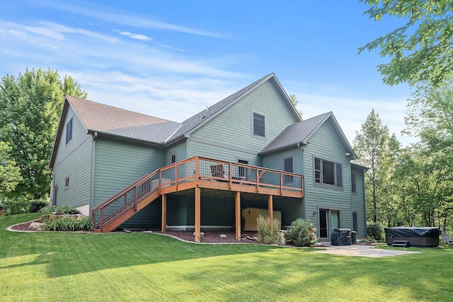 back of house with a patio area, a lawn, and a hot tub