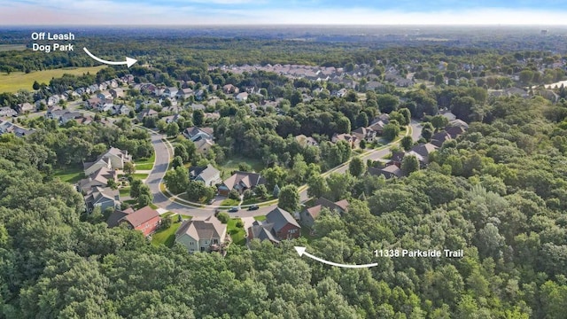 bird's eye view featuring a residential view and a wooded view