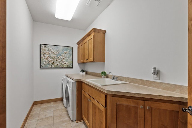 washroom with visible vents, light tile patterned flooring, cabinet space, separate washer and dryer, and a sink