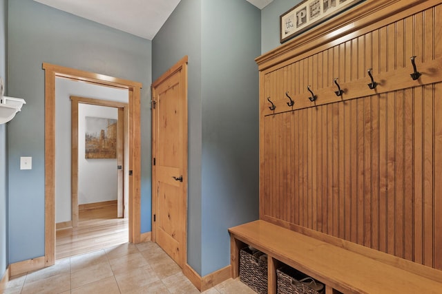 mudroom featuring light tile patterned flooring and baseboards