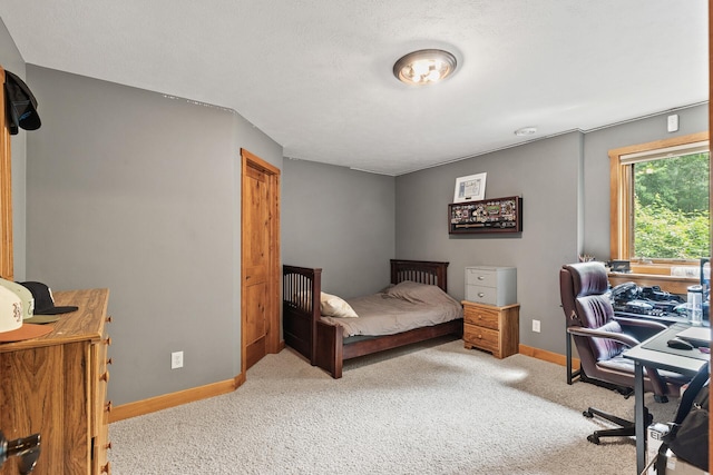 bedroom with baseboards and carpet flooring