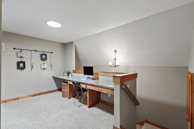 office space featuring baseboards, lofted ceiling, and carpet floors