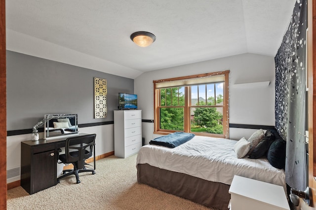 bedroom featuring vaulted ceiling, visible vents, baseboards, and carpet floors