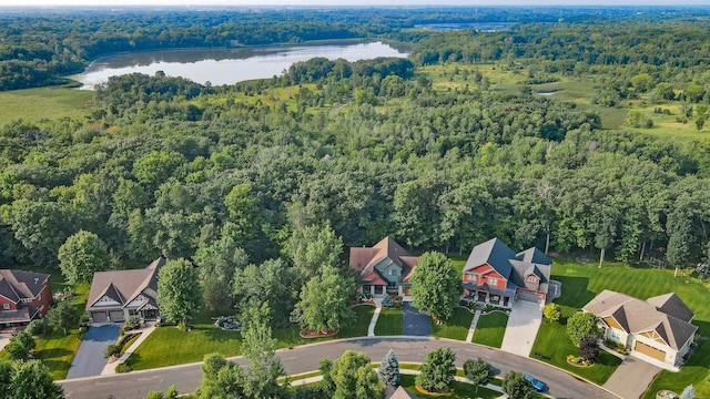 birds eye view of property with a residential view, a forest view, and a water view