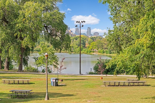 view of community with a yard and a water view