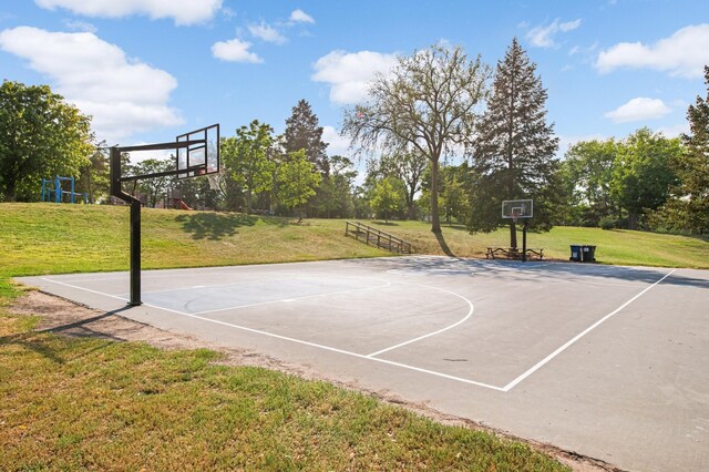 view of basketball court with a lawn