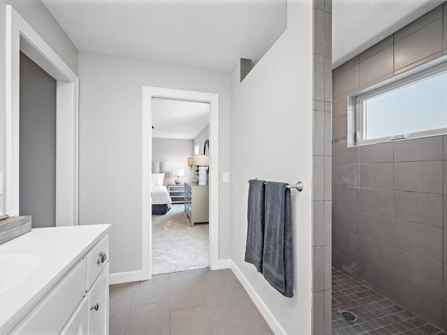 bathroom with vanity and tiled shower