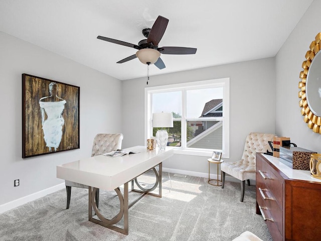 office space featuring ceiling fan and light colored carpet