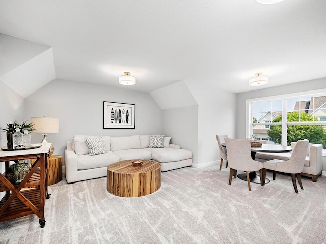 living room featuring light carpet and vaulted ceiling