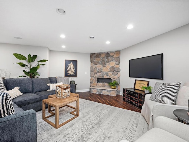 living room with hardwood / wood-style flooring and a fireplace