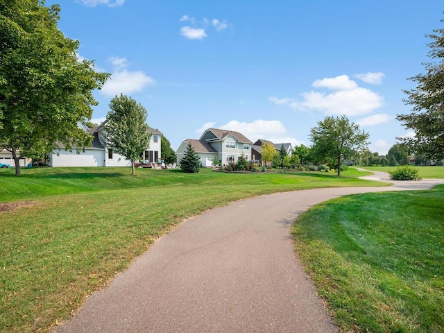 view of home's community with a yard