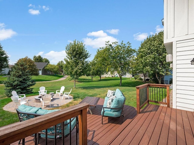 wooden terrace featuring a fire pit and a lawn