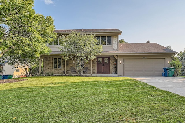 view of front of home featuring a front yard and a garage