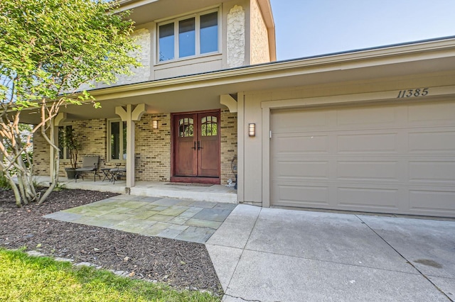 property entrance with a porch and a garage