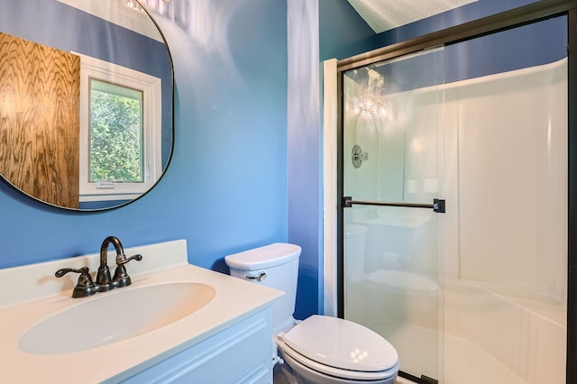 bathroom featuring vanity, toilet, and an enclosed shower