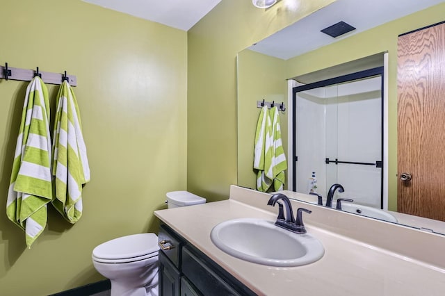 bathroom featuring vanity, a shower, and toilet