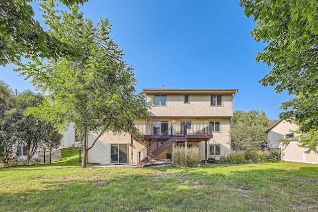 back of house with a deck and a yard