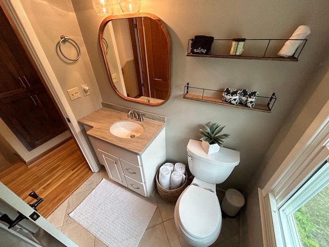 bathroom with hardwood / wood-style floors, vanity, and toilet