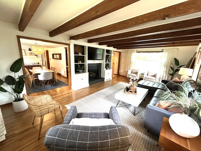 1324 Ridgeview Dr, Montevideo, MN 56265 - living room featuring beam ceiling, a fireplace, and wood finished floors