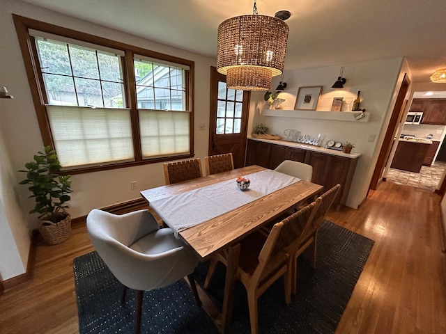 1324 Ridgeview Dr, Montevideo, MN 56265 - dining room with a notable chandelier, baseboards, and wood finished floors