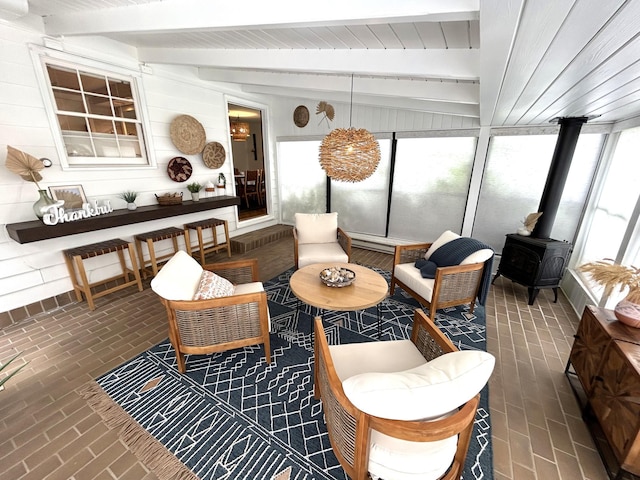 1324 Ridgeview Dr, Montevideo, MN 56265 - sunroom featuring a wood stove, a wealth of natural light, and beamed ceiling