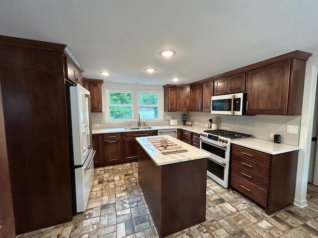 1324 Ridgeview Dr, Montevideo, MN 56265 - kitchen with stainless steel appliances, a sink, light countertops, and dark brown cabinetry