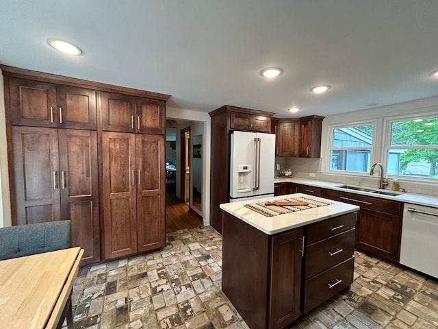 1324 Ridgeview Dr, Montevideo, MN 56265 - kitchen with recessed lighting, white appliances, a kitchen island, a sink, and light countertops
