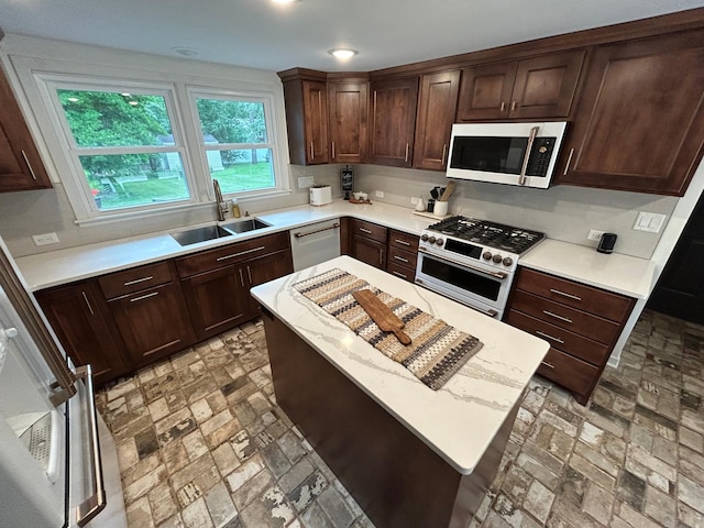 1324 Ridgeview Dr, Montevideo, MN 56265 - kitchen with dark brown cabinetry, tasteful backsplash, a kitchen island, stainless steel appliances, and a sink